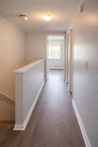 a view of a hallway with wooden floor