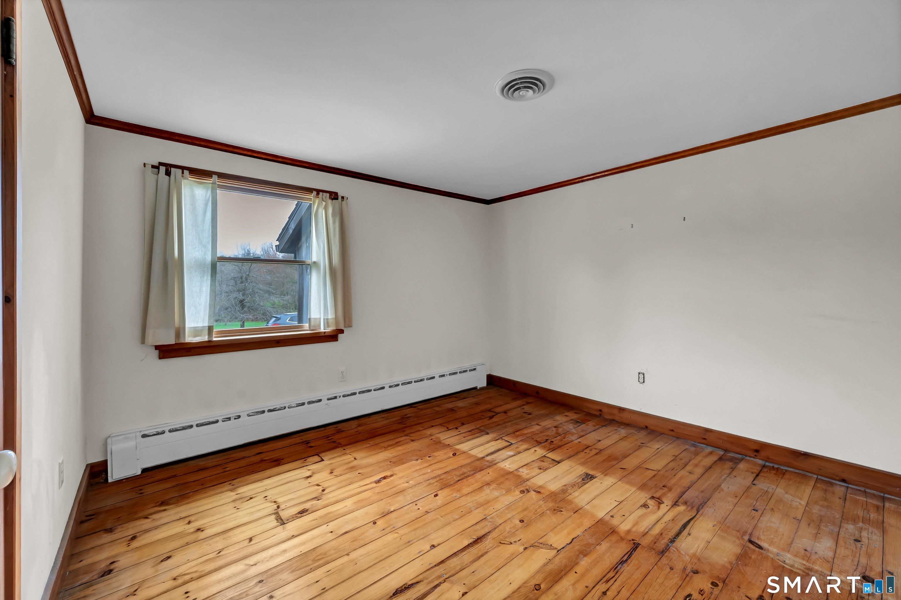 139 West Side Road Goshen, CT 06756 - Photo 7 of 17 a view of an empty room with wooden floor and a window