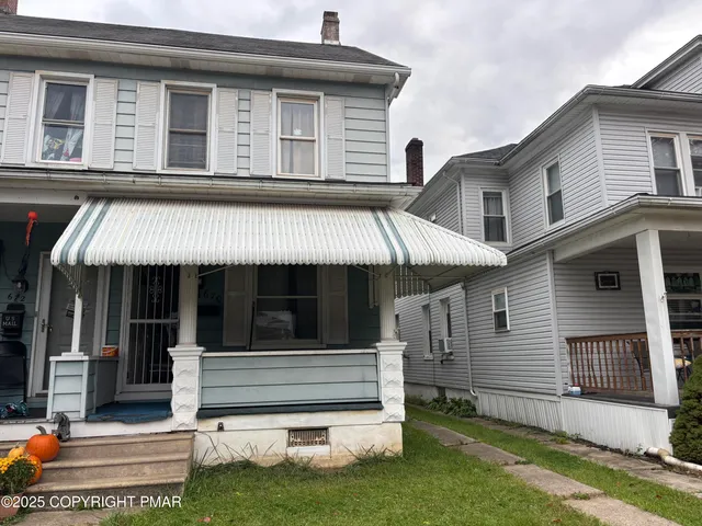 a front view of a house with a balcony and garage