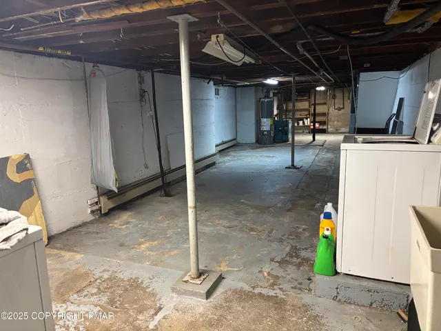 a room with water heater and a cabinet