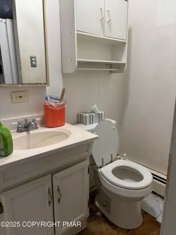 a bathroom with a toilet a sink and a mirror