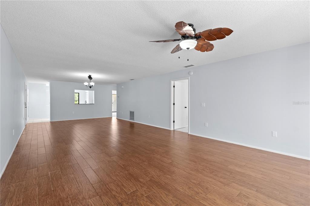 6110 Country Club Way, Unit 204 Sarasota, FL 34243 - Photo 11 of 66 a view of an empty room with wooden floor and a ceiling fan