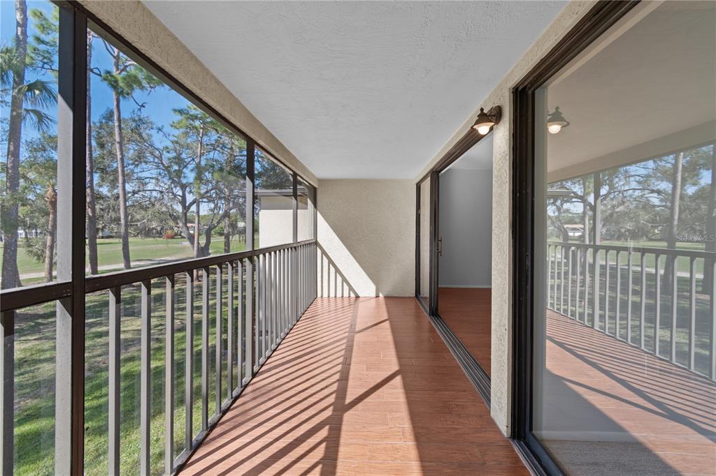 6110 Country Club Way, Unit 204 Sarasota, FL 34243 - Photo 17 of 66 a view of a balcony with wooden floor