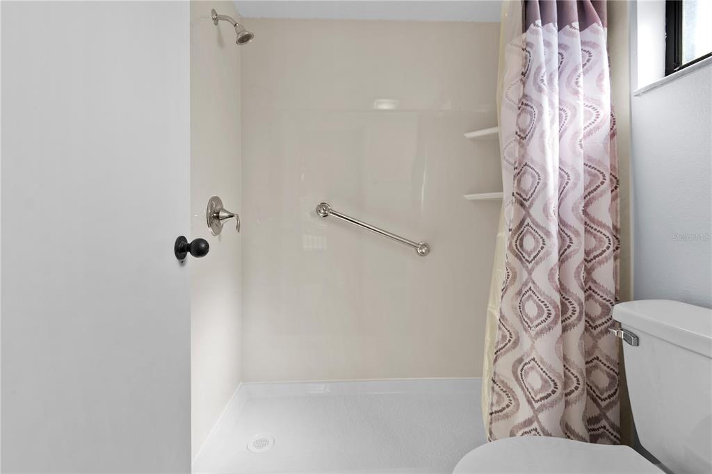 6110 Country Club Way, Unit 204 Sarasota, FL 34243 - Photo 24 of 66 a bathroom with a bathtub and shower curtain