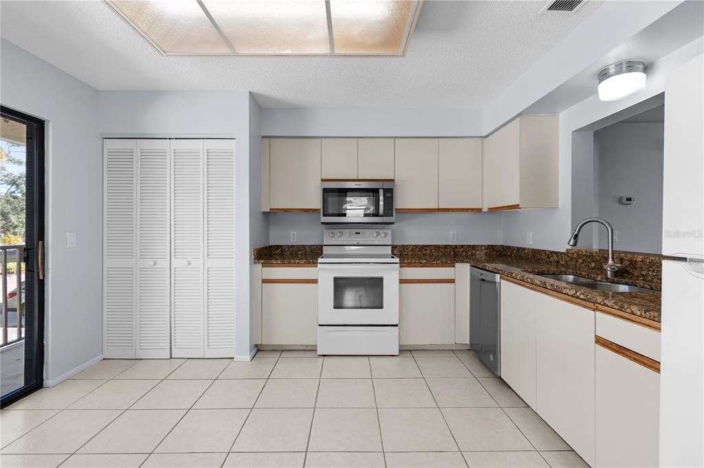 6110 Country Club Way, Unit 204 Sarasota, FL 34243 - Photo 34 of 66 a kitchen with a stove a sink and a microwave