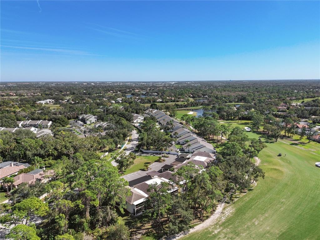 6110 Country Club Way, Unit 204 Sarasota, FL 34243 - Photo 59 of 66 an aerial view of residential houses with outdoor space and trees