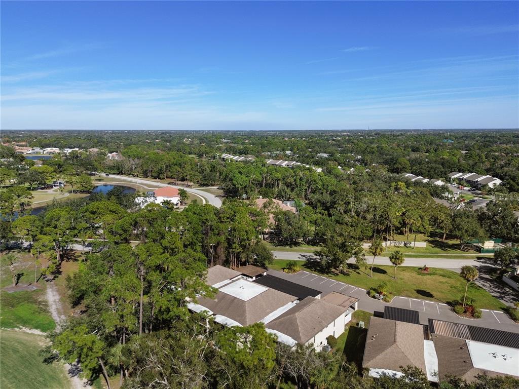 6110 Country Club Way, Unit 204 Sarasota, FL 34243 - Photo 62 of 66 an aerial view of residential houses with outdoor space and trees