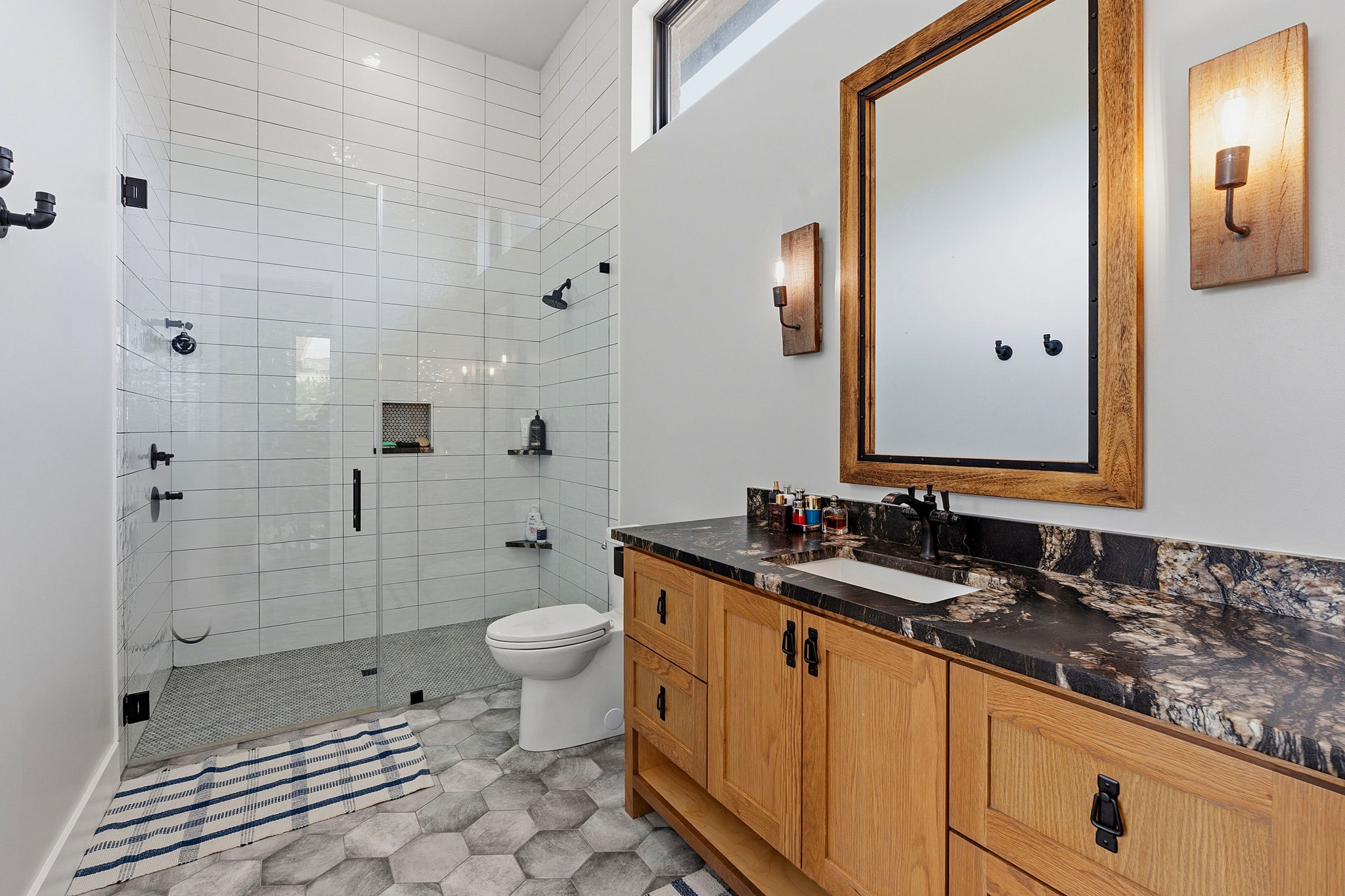 194 Placid Way Spring Branch, TX 78070 - Photo 17 of 37 a bathroom with a double vanity sink toilet and shower