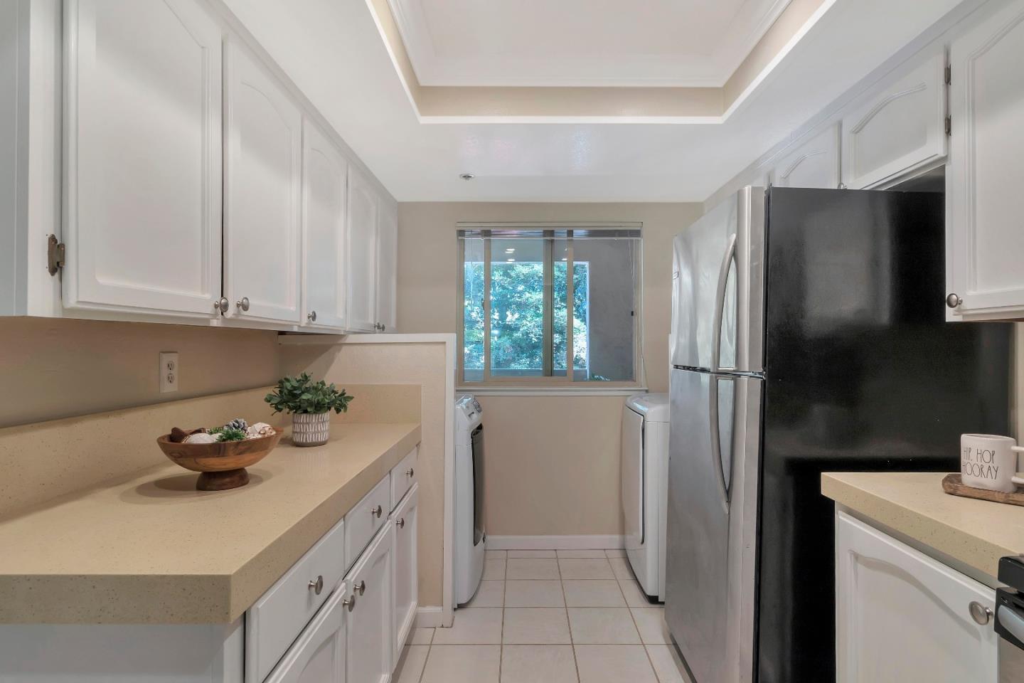 20682 Celeste Circle Cupertino, CA 95014 - Photo 11 of 31 a kitchen with a refrigerator sink and cabinets