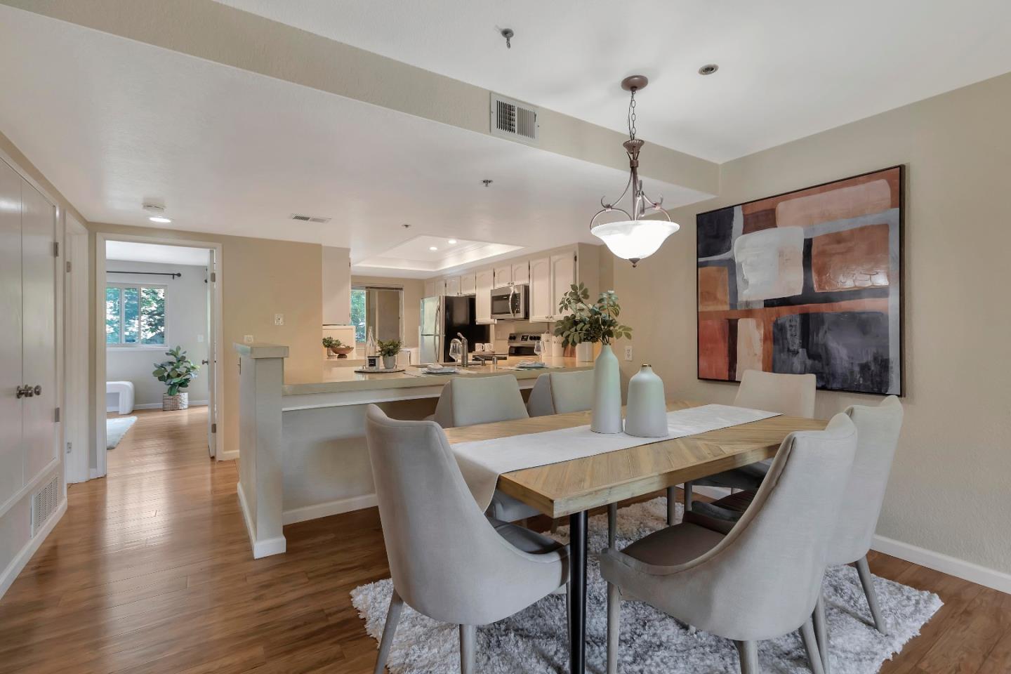 20682 Celeste Circle Cupertino, CA 95014 - Photo 15 of 31 a view of a dining room and livingroom with furniture wooden floor a chandelier