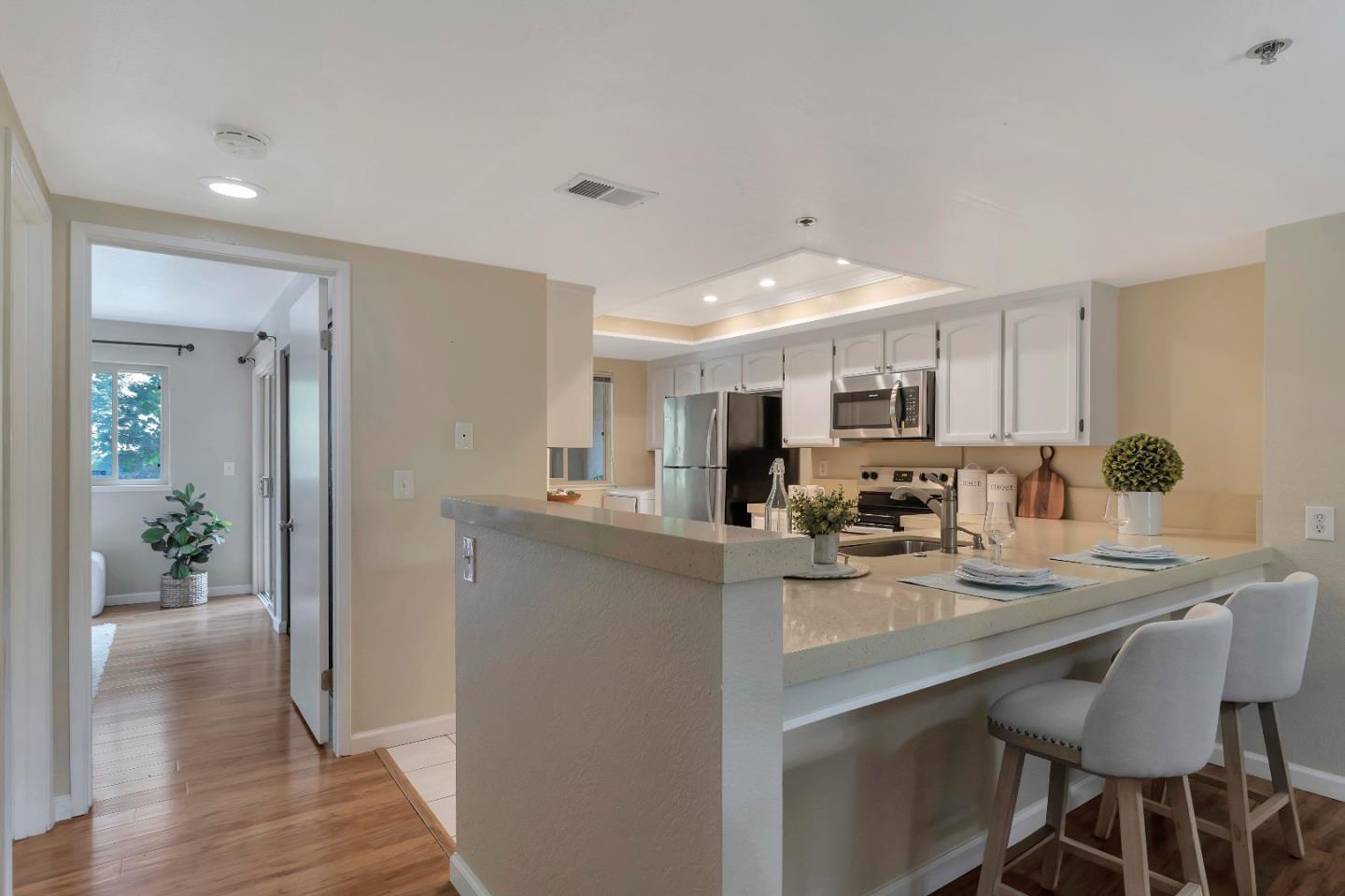 20682 Celeste Circle Cupertino, CA 95014 - Photo 16 of 31 a kitchen with kitchen island granite countertop a table and chairs in it