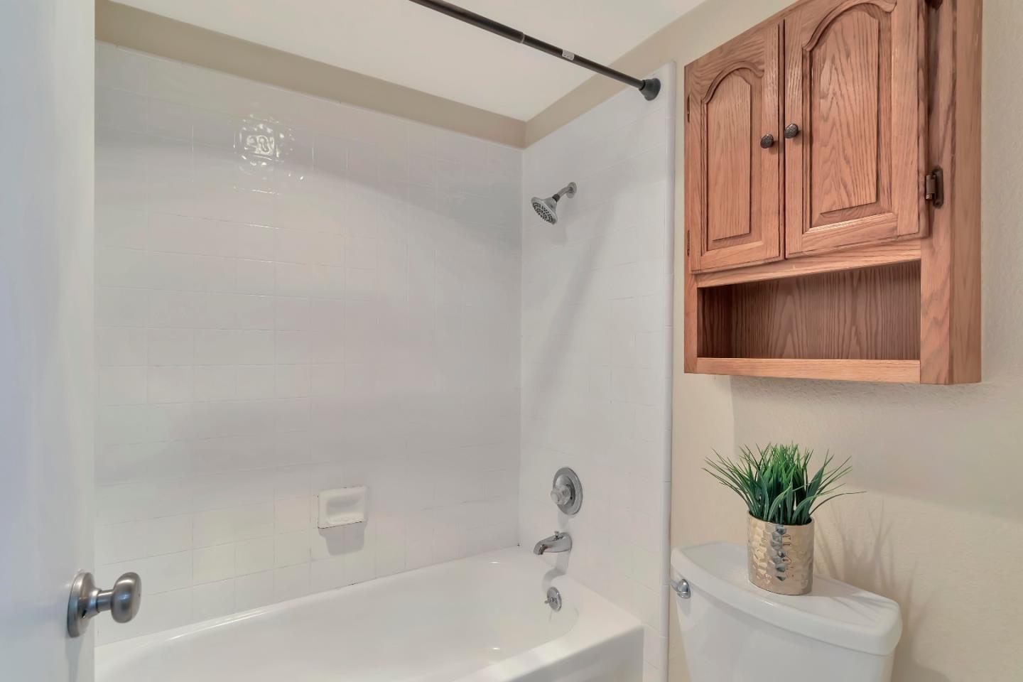 20682 Celeste Circle Cupertino, CA 95014 - Photo 21 of 31 a bathroom with a sink a bath tub and a shower