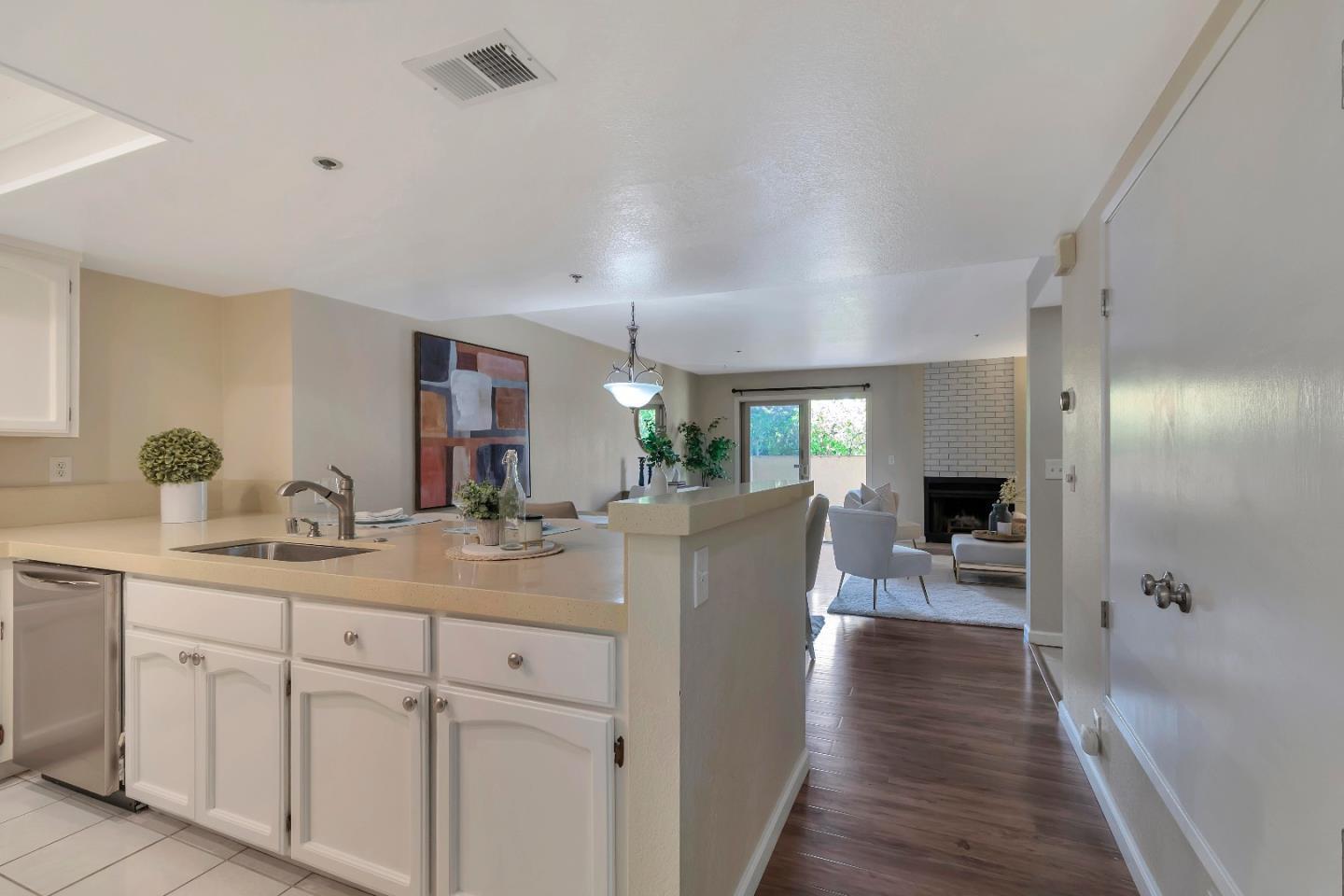 20682 Celeste Circle Cupertino, CA 95014 - Photo 8 of 31 a dining hall with stainless steel appliances granite countertop a sink dishwasher and a wooden floor