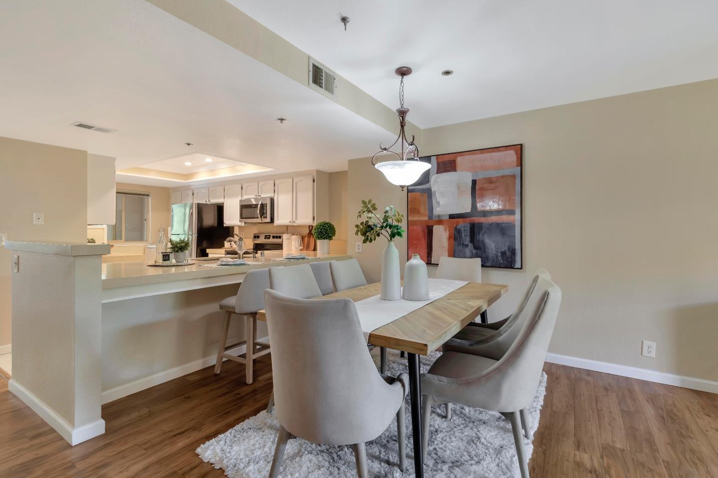 20682 Celeste Circle Cupertino, CA 95014 - Photo 9 of 31 a view of a dining room and livingroom with furniture wooden floor a rug a chandelier