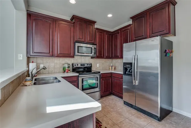 a kitchen with a refrigerator sink and microwave