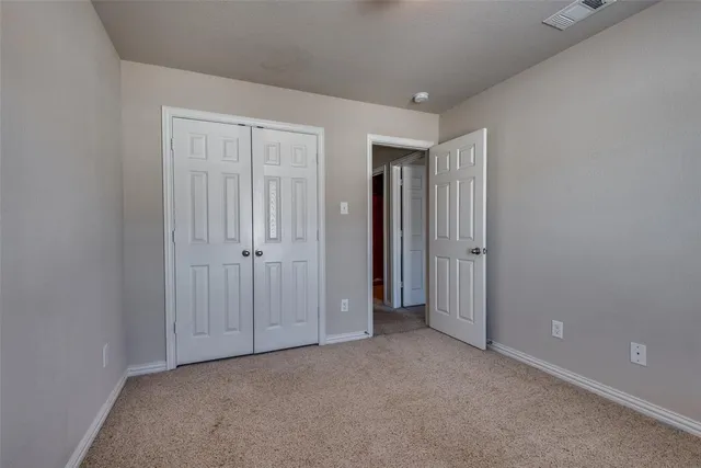 an empty room with closet area
