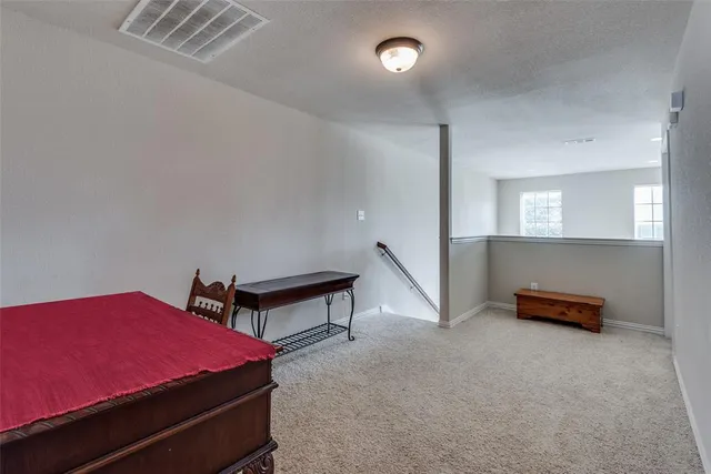 a bedroom with furniture and a potted plant