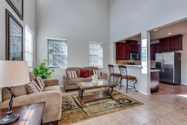 a living room with furniture a flat screen tv and a table