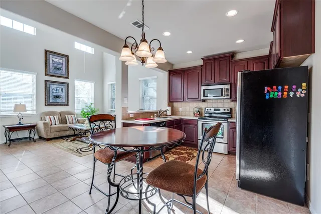 a view of a dining room with furniture and a chandelier