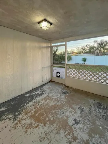 a view of a room with an empty space and a window