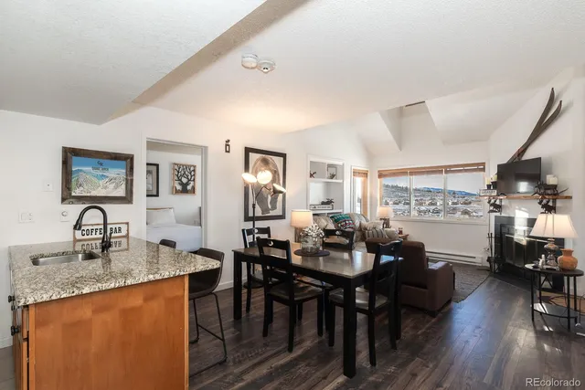 a view of a a dining room with furniture window and wooden floor
