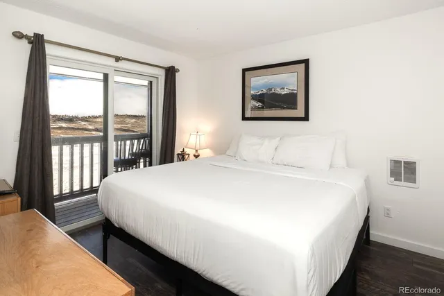 a bedroom with a large bed and a large window