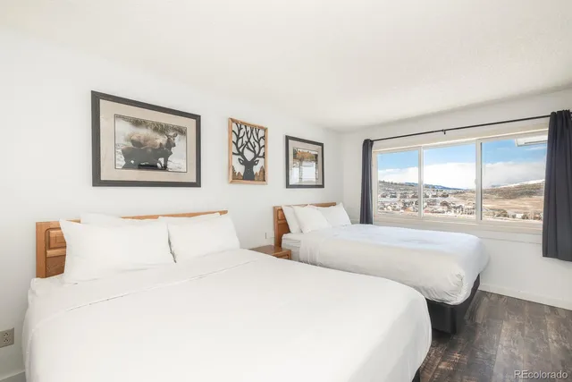 a bedroom with a large bed and a large window