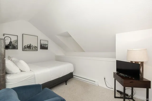 a bedroom with a bed and a chair