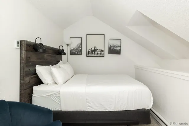 a bed sitting in a bedroom and table