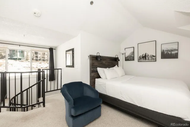 a bedroom with a bed and a couch