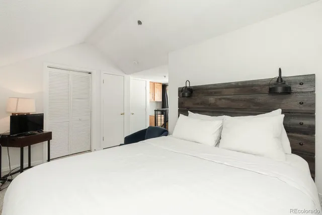 a bedroom with a bed and a desk