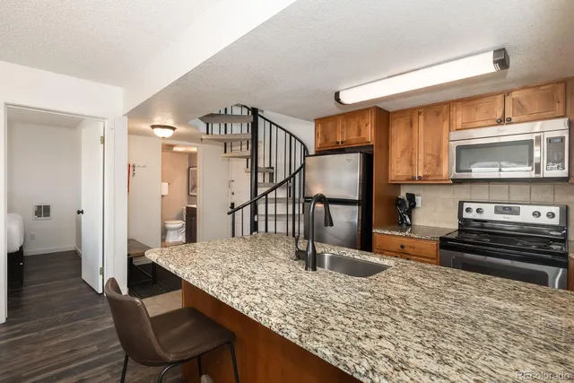 a kitchen with sink refrigerator and stove