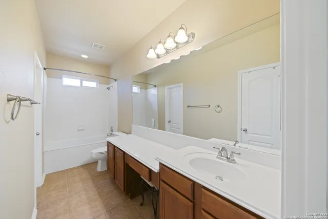 a bathroom with a sink a vanity and a mirror