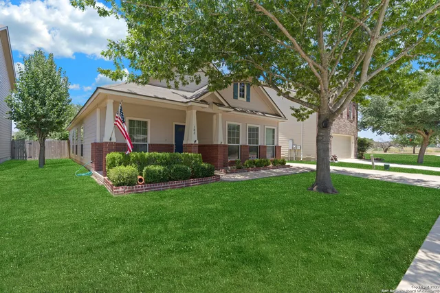 a front view of house with yard and green space