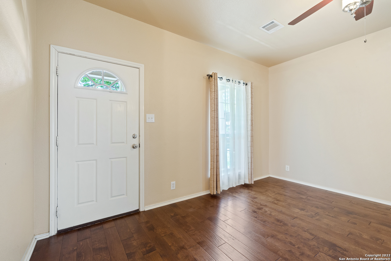 308 Rustic Trail Cibolo, TX 78108 - Photo 5 of 25 an empty room with wooden floor and windows