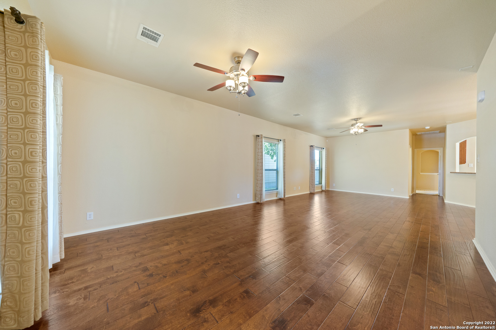 308 Rustic Trail Cibolo, TX 78108 - Photo 6 of 25 a view of an empty room with wooden floor and a ceiling fan