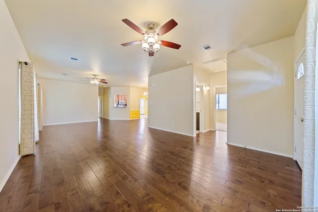 wooden floor in an empty room with a window