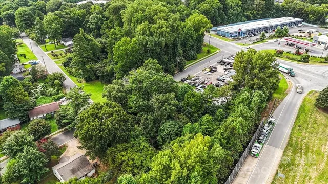 an aerial view of residential house with outdoor space and trees all around