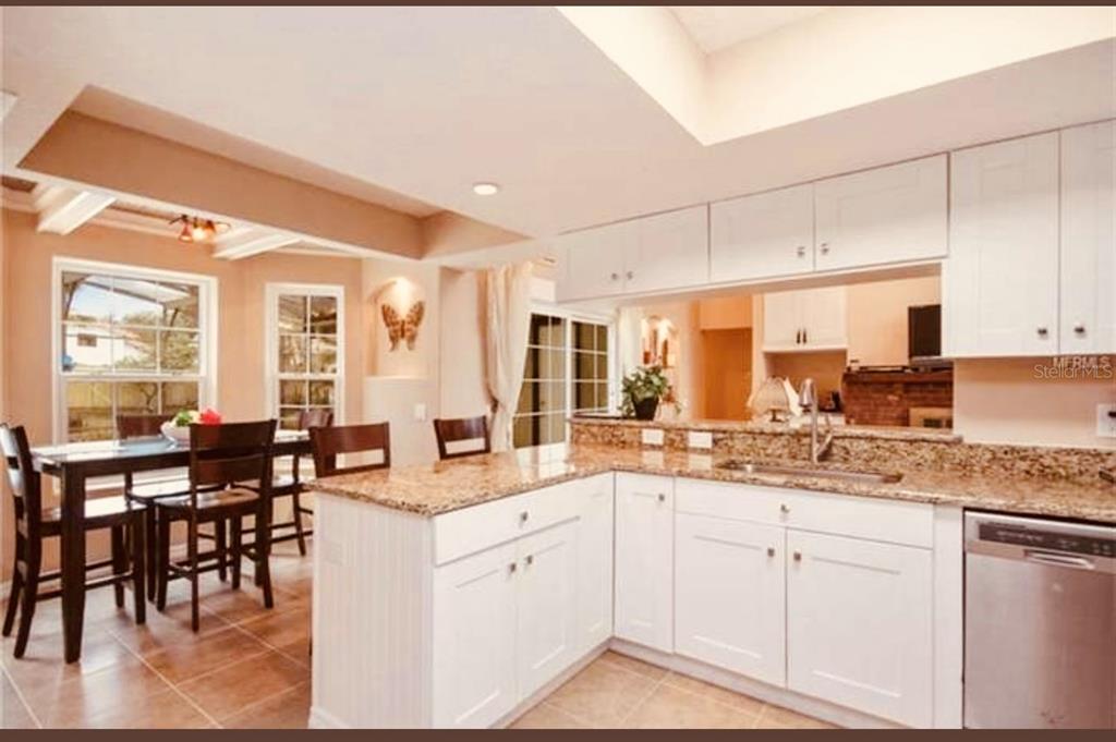 6850 Spring Rain Drive Orlando, FL 32819 - Photo 14 of 35 a kitchen with white cabinets and sink