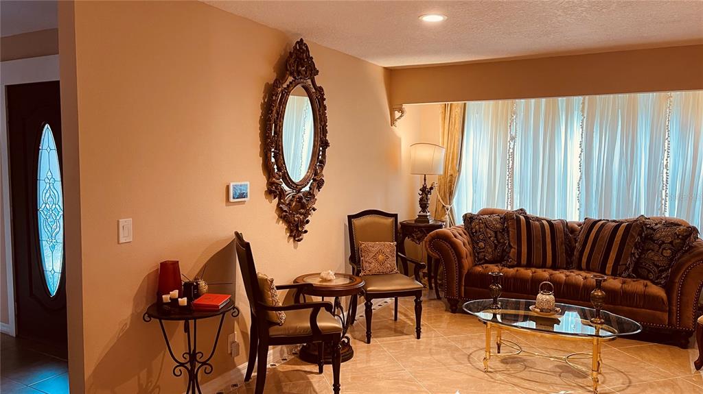 6850 Spring Rain Drive Orlando, FL 32819 - Photo 15 of 35 a living room with furniture and a large window