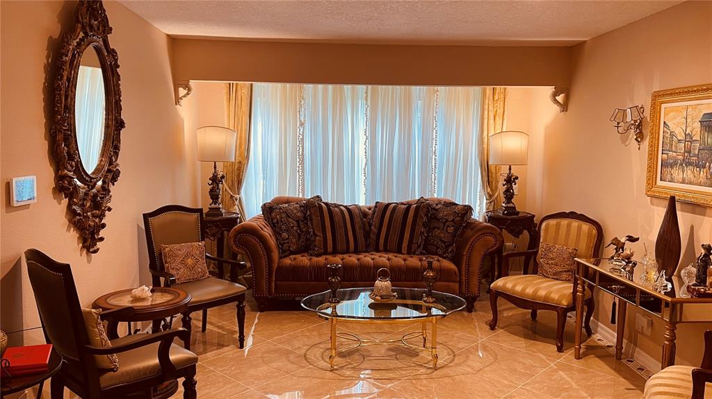 6850 Spring Rain Drive Orlando, FL 32819 - Photo 16 of 35 a living room with furniture a rug and a large window