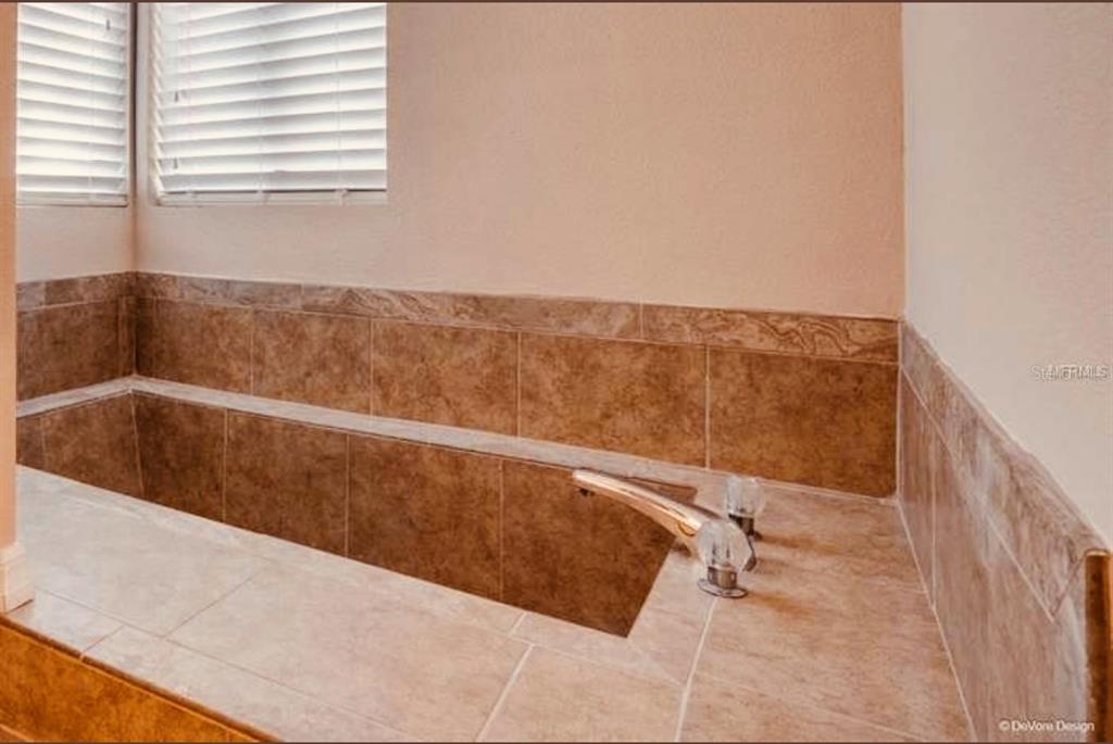 6850 Spring Rain Drive Orlando, FL 32819 - Photo 21 of 35 a view of wooden floor and bathroom
