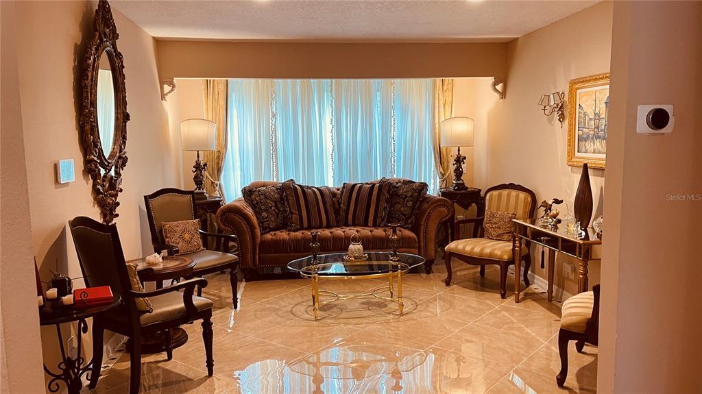 6850 Spring Rain Drive Orlando, FL 32819 - Photo 24 of 35 a living room with furniture and a large window