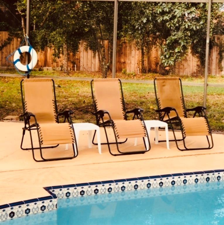 6850 Spring Rain Drive Orlando, FL 32819 - Photo 25 of 35 a view of swimming pool with outdoor seating