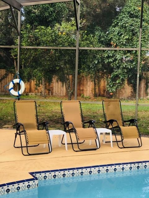 6850 Spring Rain Drive Orlando, FL 32819 - Photo 27 of 35 a view of a chairs and table in the patio