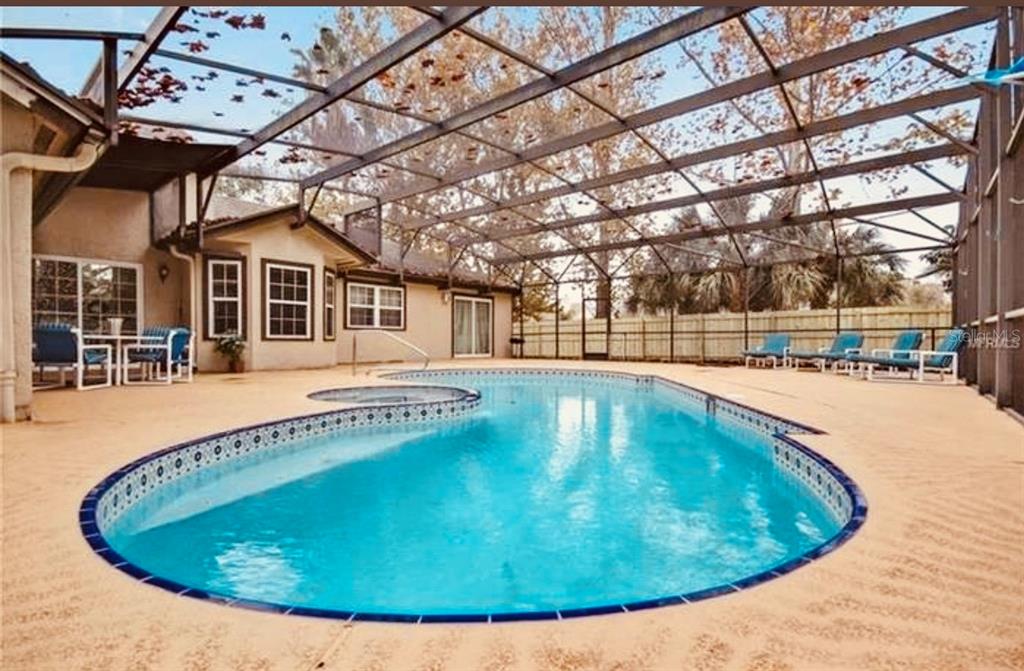 6850 Spring Rain Drive Orlando, FL 32819 - Photo 28 of 35 a view of a swimming pool with a patio
