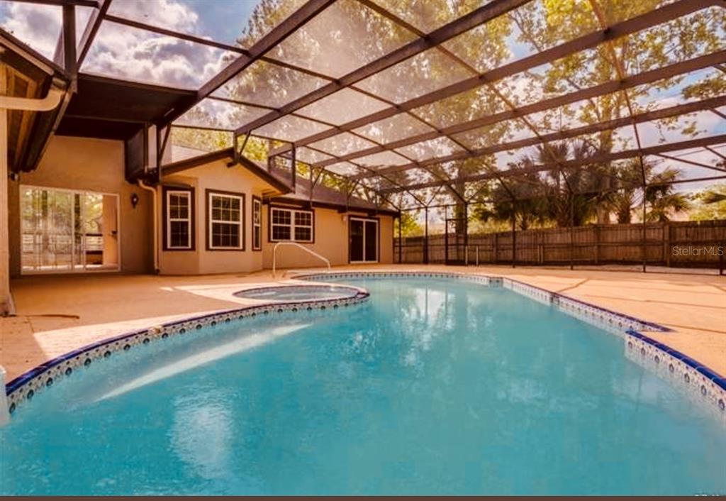 6850 Spring Rain Drive Orlando, FL 32819 - Photo 29 of 35 a view of a house with a big yard