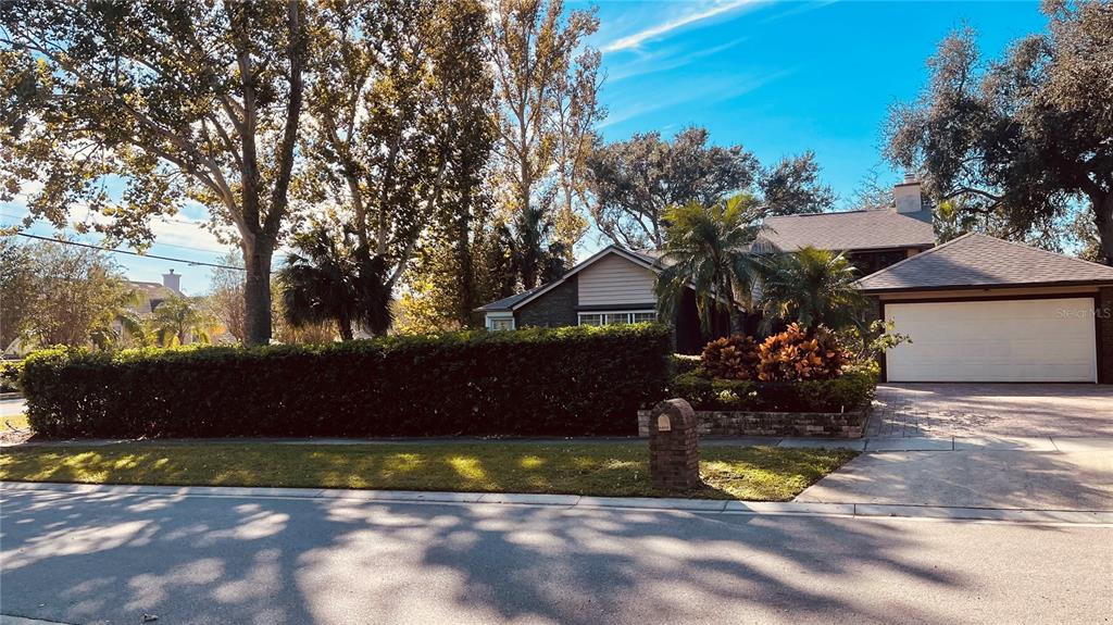 6850 Spring Rain Drive Orlando, FL 32819 - Photo 3 of 35 a view of a house with a yard