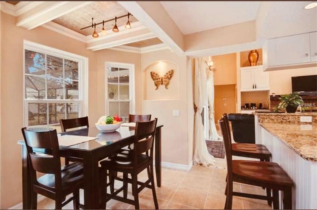 6850 Spring Rain Drive Orlando, FL 32819 - Photo 6 of 35 a view of a dining room with furniture and wooden floor