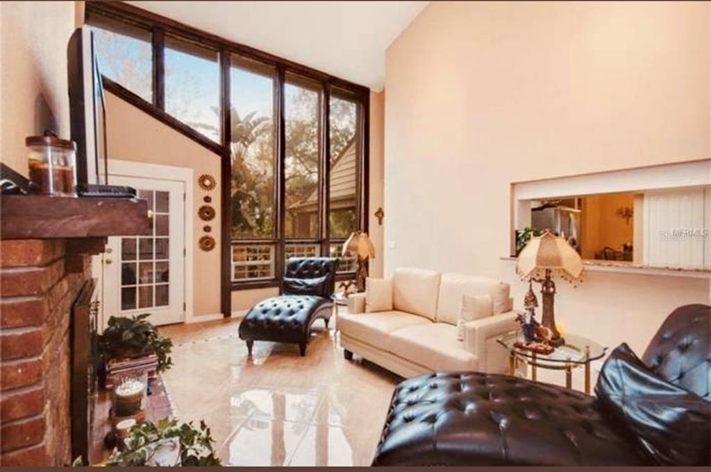 6850 Spring Rain Drive Orlando, FL 32819 - Photo 8 of 35 a living room with furniture and a large window